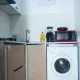 Kitchen equipped with washing machine and microwave